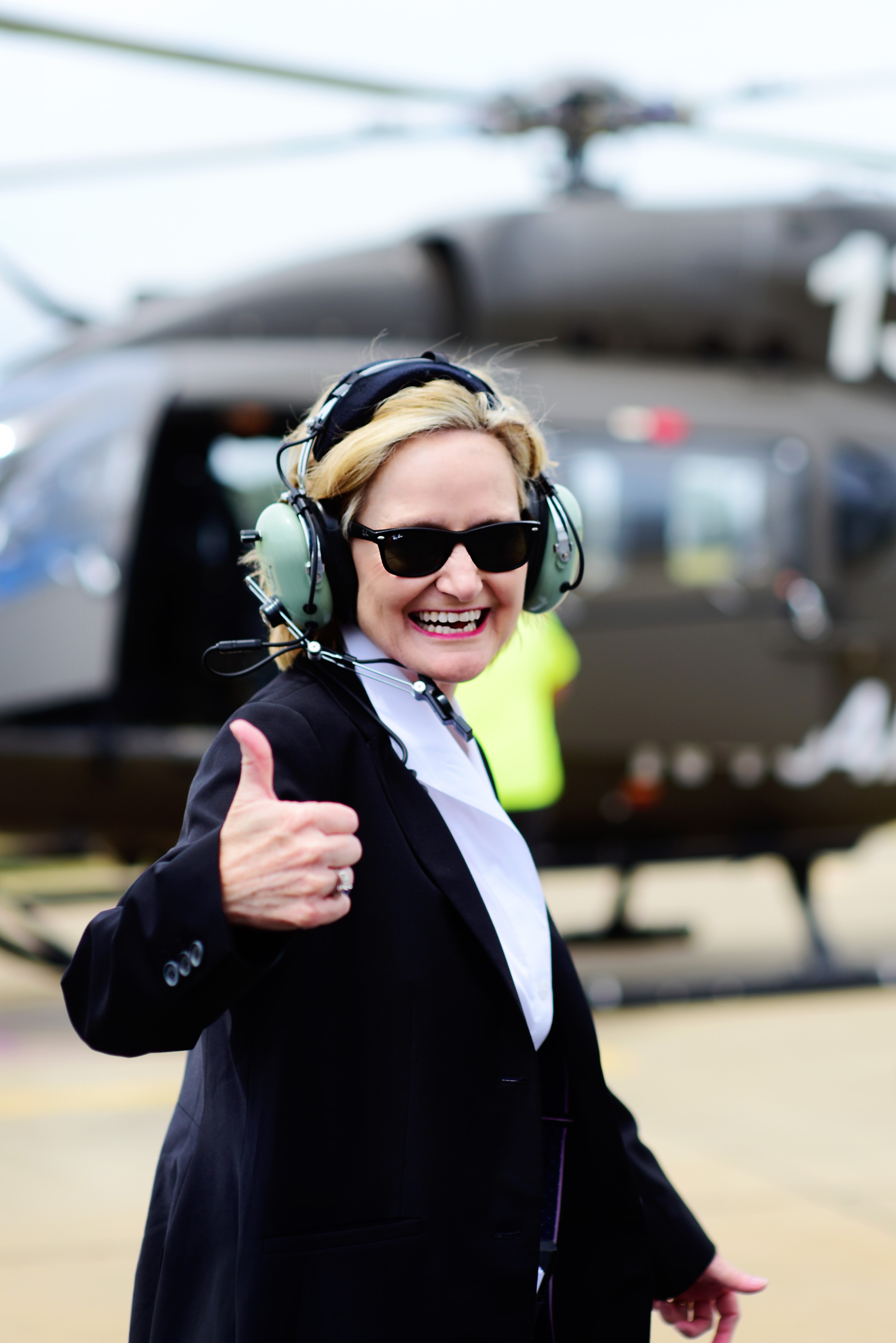 Senator Hyde-Smith signals thumbs up before boarding a Mississippi-made UH-72A Lakota helicopter