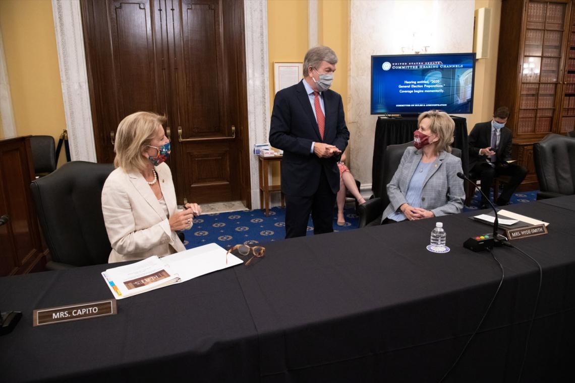 Senator Hyde-Smith visits with Senators Shelley Moore Capito (R-W.Va.) and Roy Blunt (R-Mo.) during a Rules Committee Hearing. (July 22, 2020)
