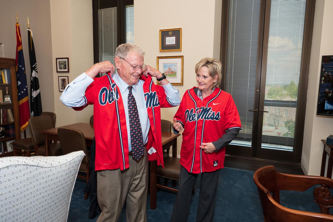 Senators Hyde-Smith and Jim Inhofe (R-Okla.) settle a wager after the Ole Miss baseball team beat Oklahoma to win the College World Series. (July 20, 2022)