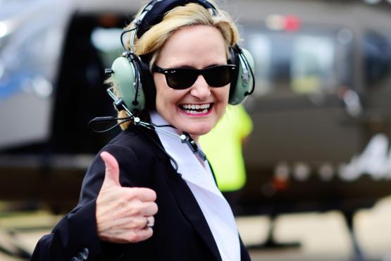 Senator Hyde-Smith signals thumbs up before boarding a Mississippi-made UH-72A Lakota helicopter
