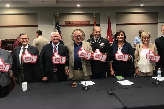 Senator Hyde-Smith joins in a thumbs-up salute for a DeSoto County-Army Corps flood control agreement