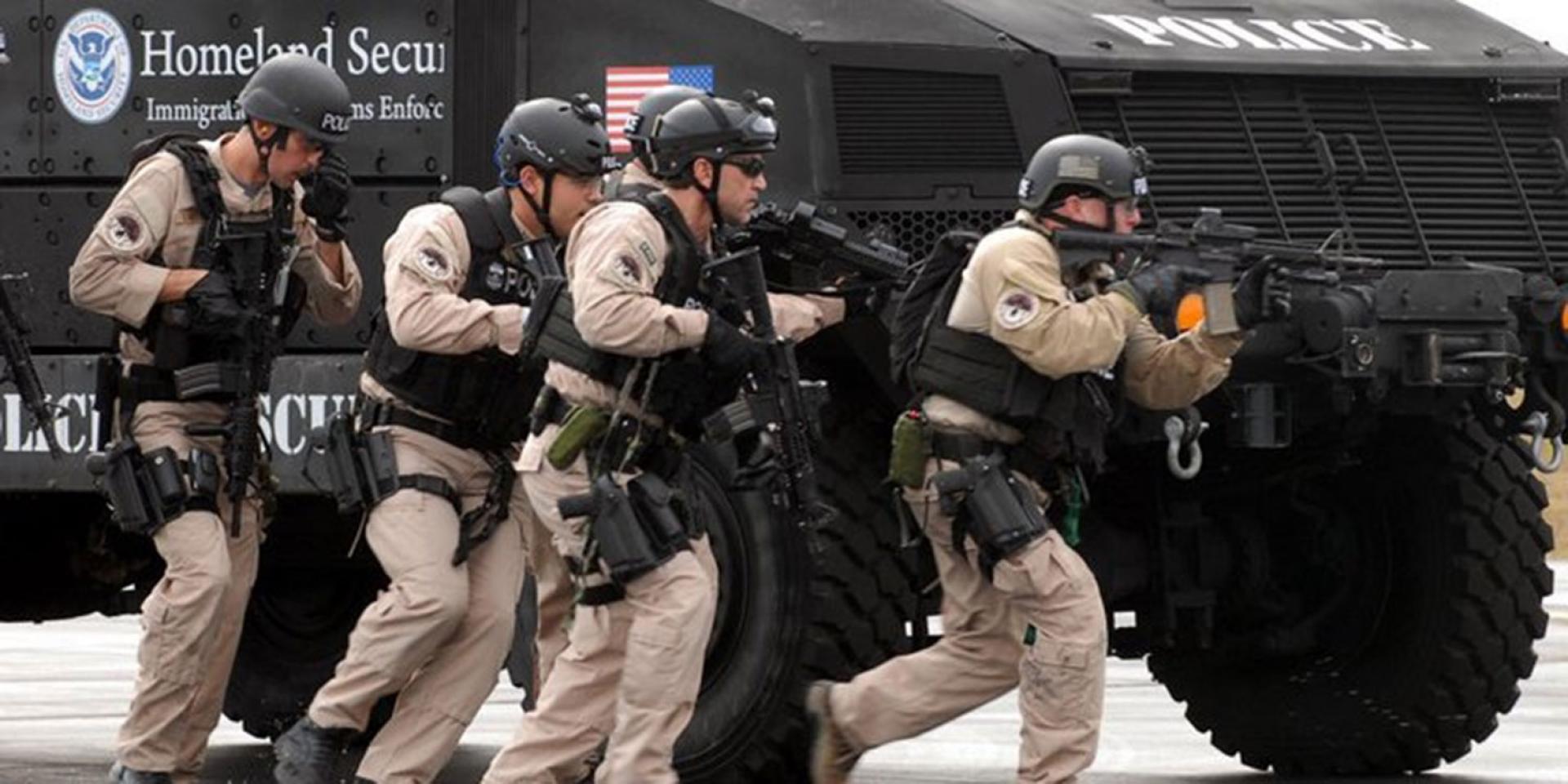 Photo of ICE Police with guns and armored vehicle