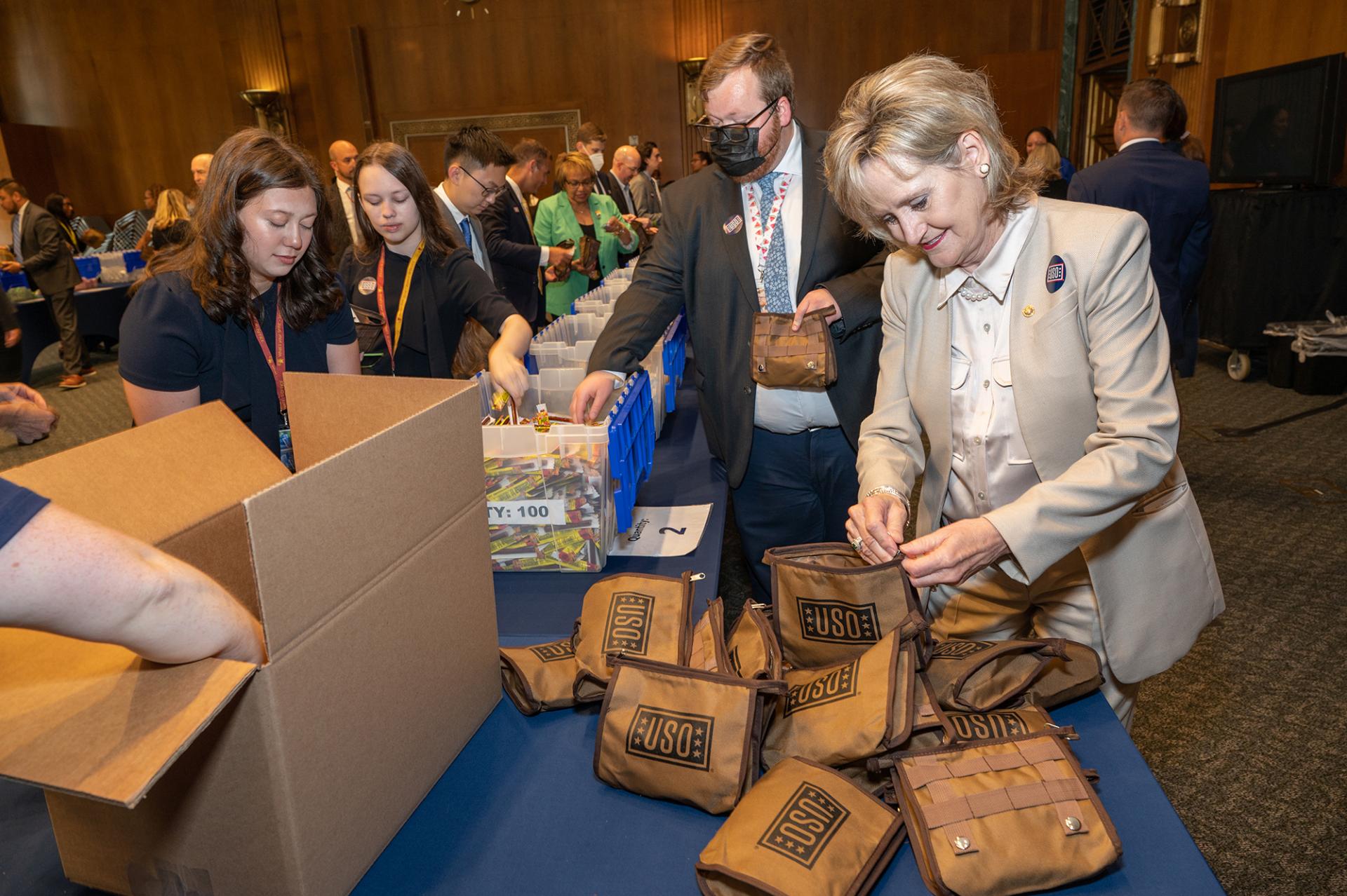 Senator Hyde-Smith joins Senate volunteers to assemble USO care packages for use by U.S. servicemembers. (July 27, 2022)